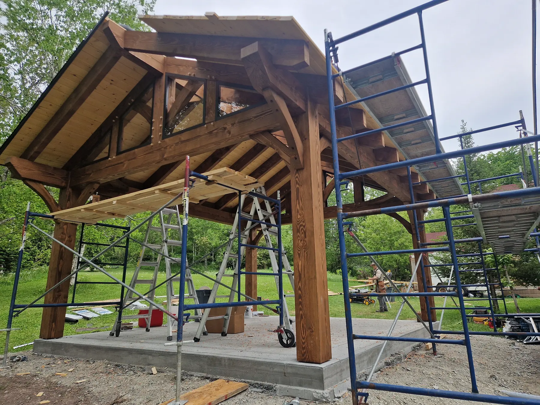 Petite halte en charpente bois en cours de construction dans un environnement arboré